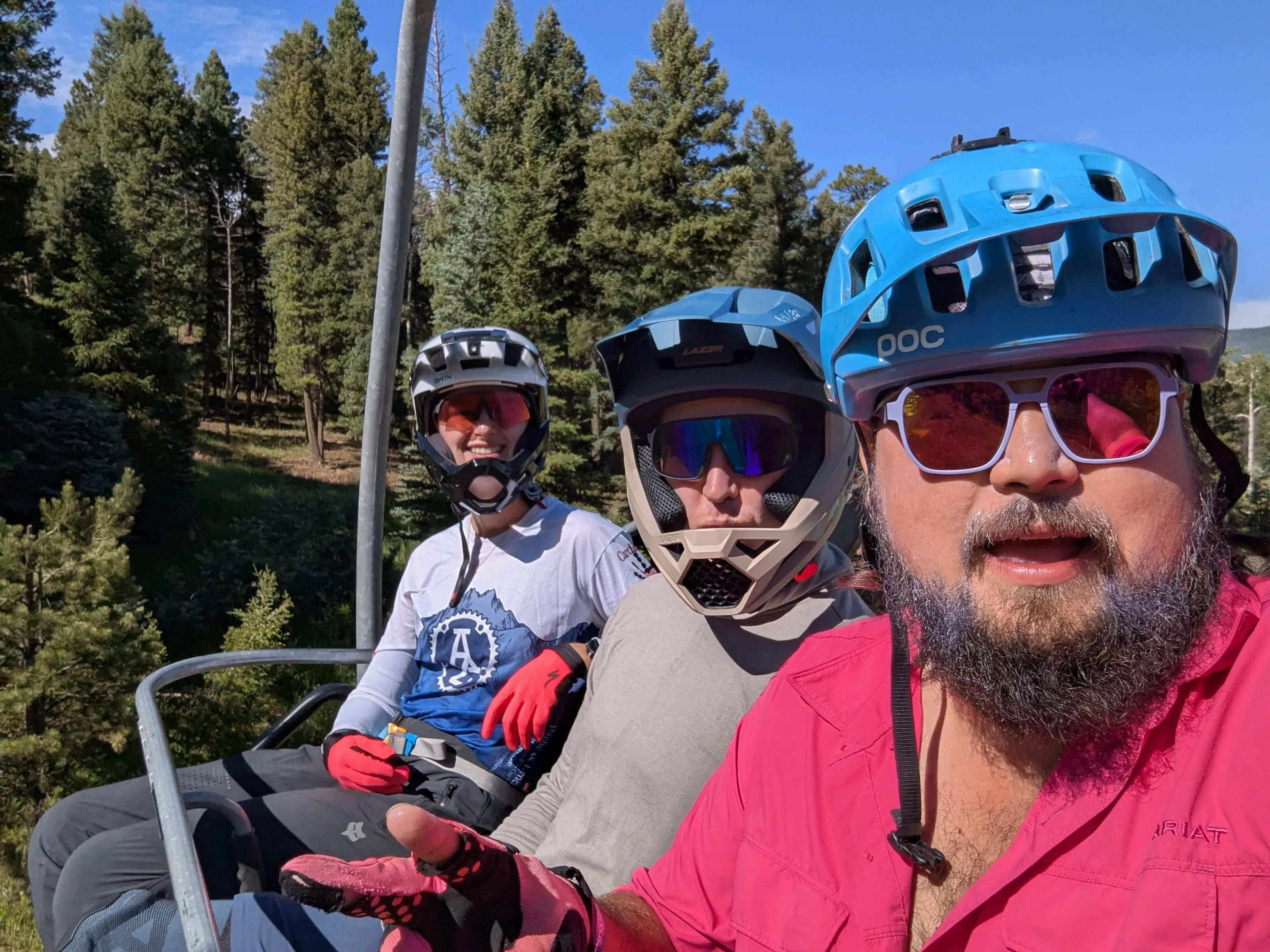 Shota with friends on a chairlift, mountain biking in the trees